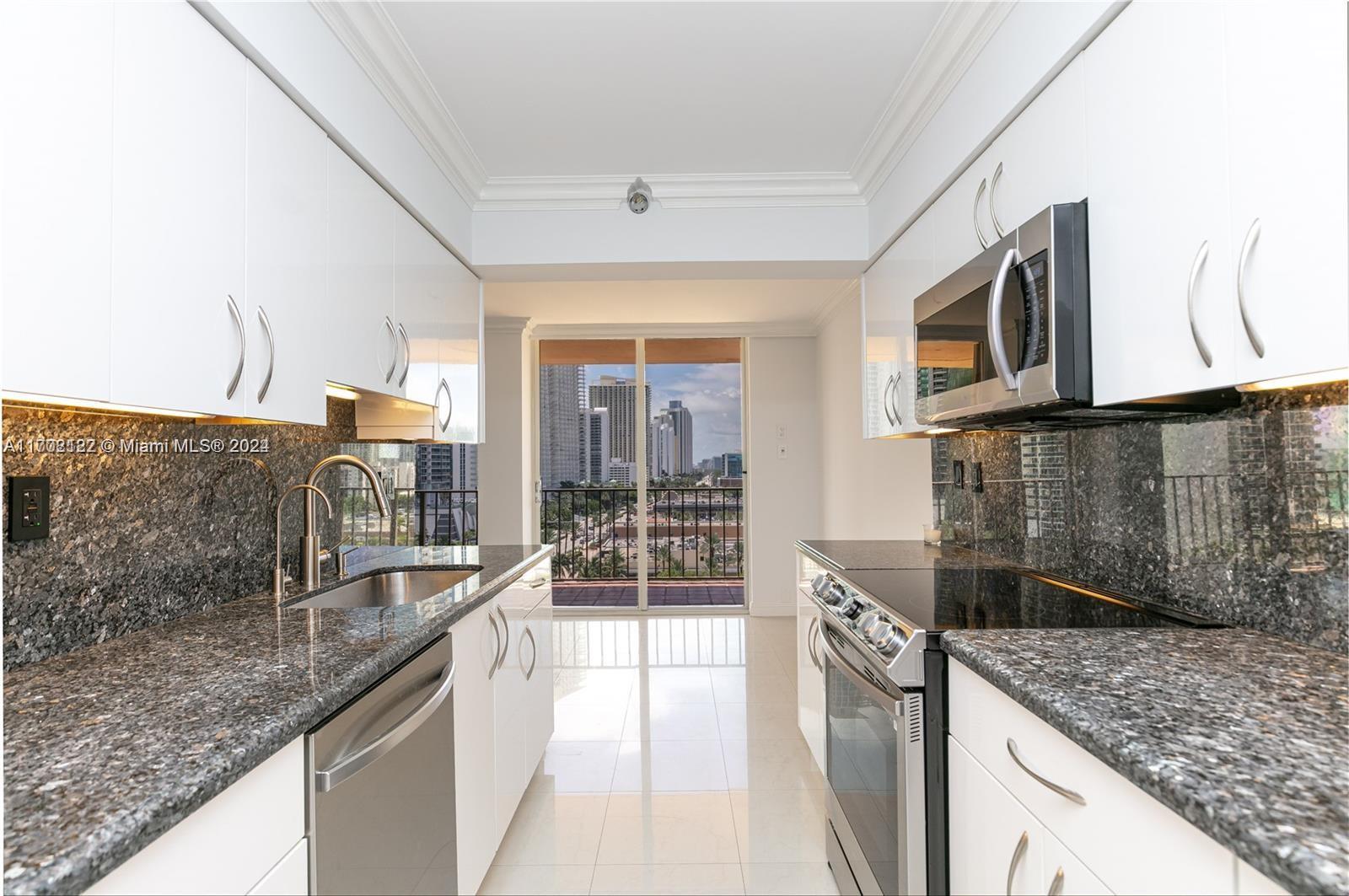 a kitchen with stainless steel appliances granite countertop a sink and a stove