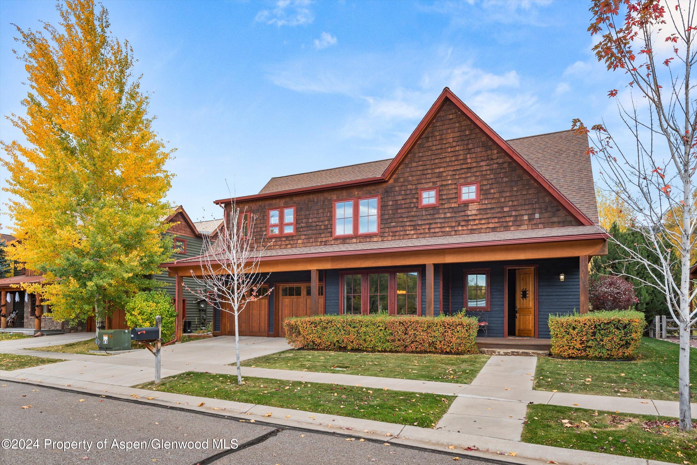 front view of a brick house with a yard