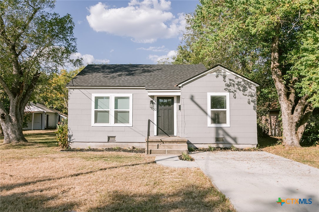 a front view of a house with a yard