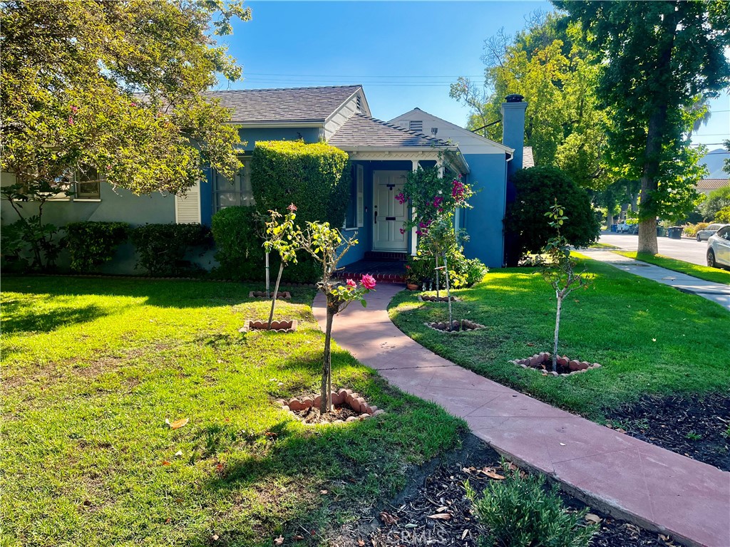 a front view of a house with garden