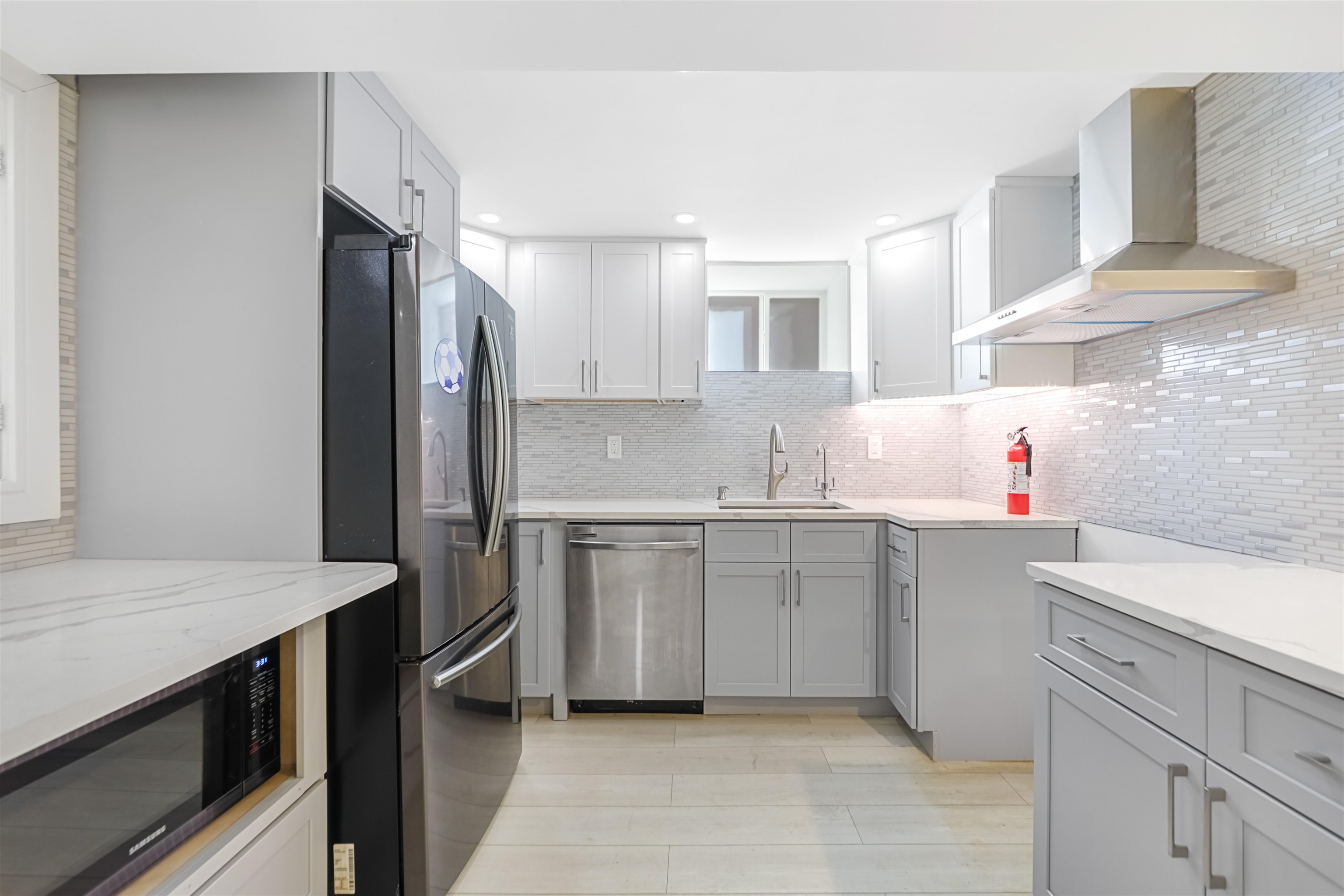 a kitchen with a sink stove and refrigerator