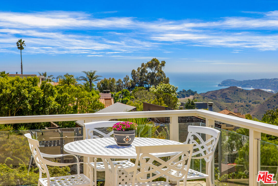 a view of a balcony with mountain view and wooden floor