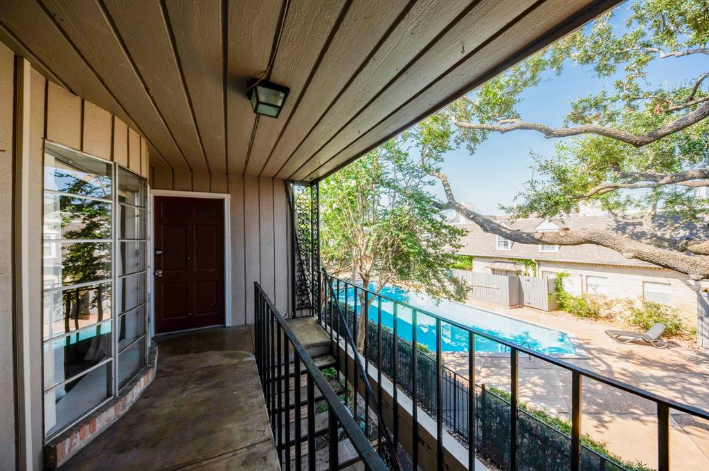 a view of balcony with wooden floor