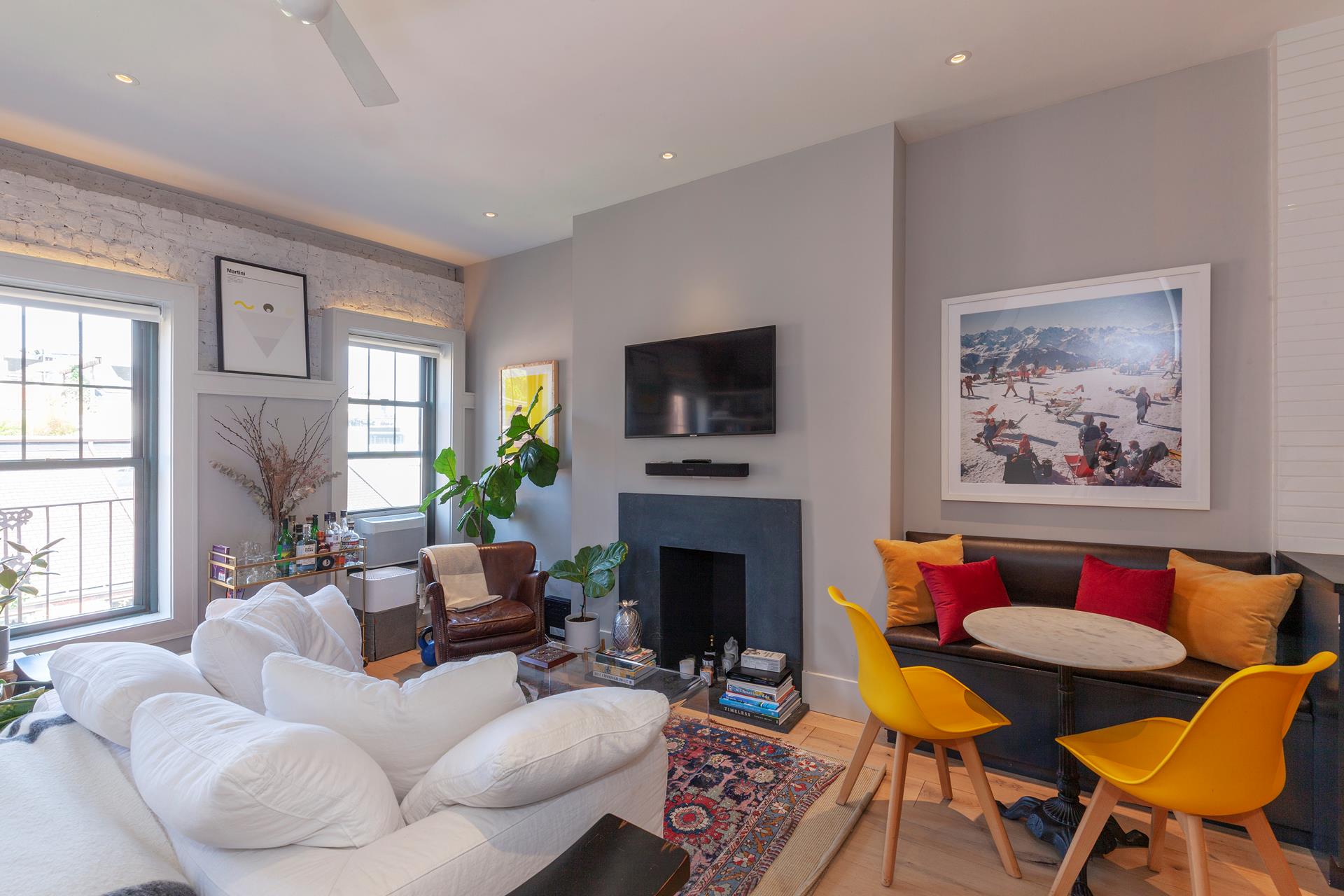 a living room with furniture a fireplace and a flat screen tv