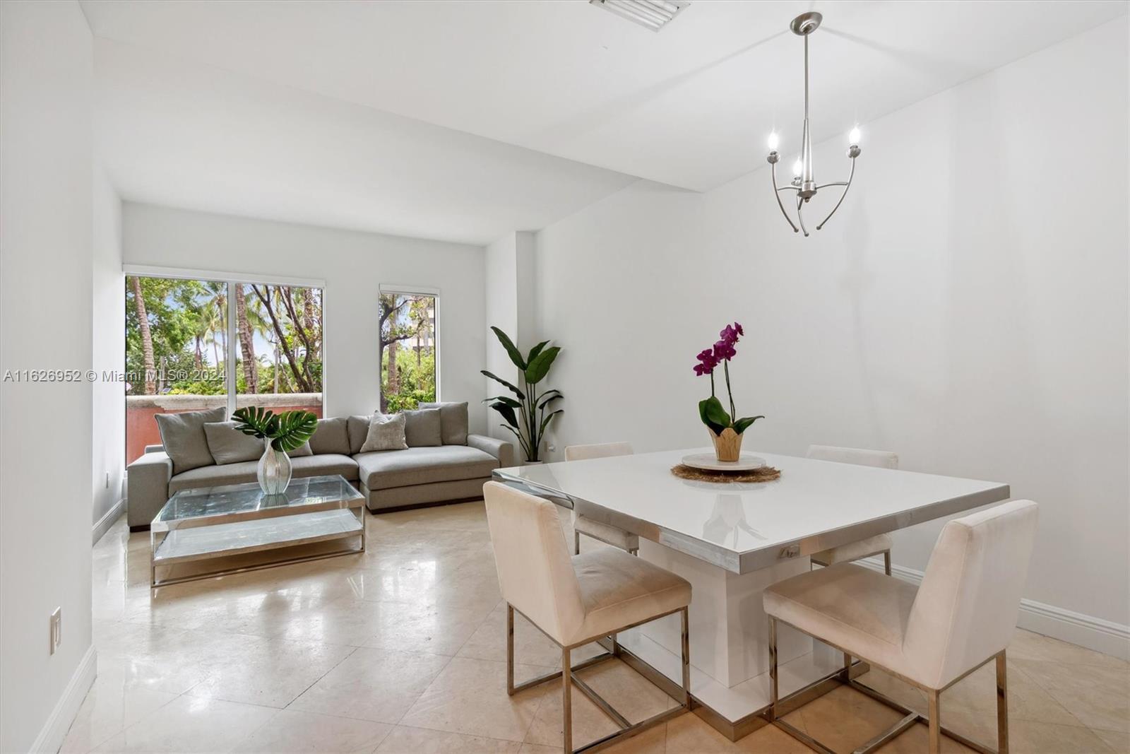 a view of a dining room with furniture wooden floor and a chandelier