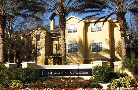 a view of a large building with a tree in front of it