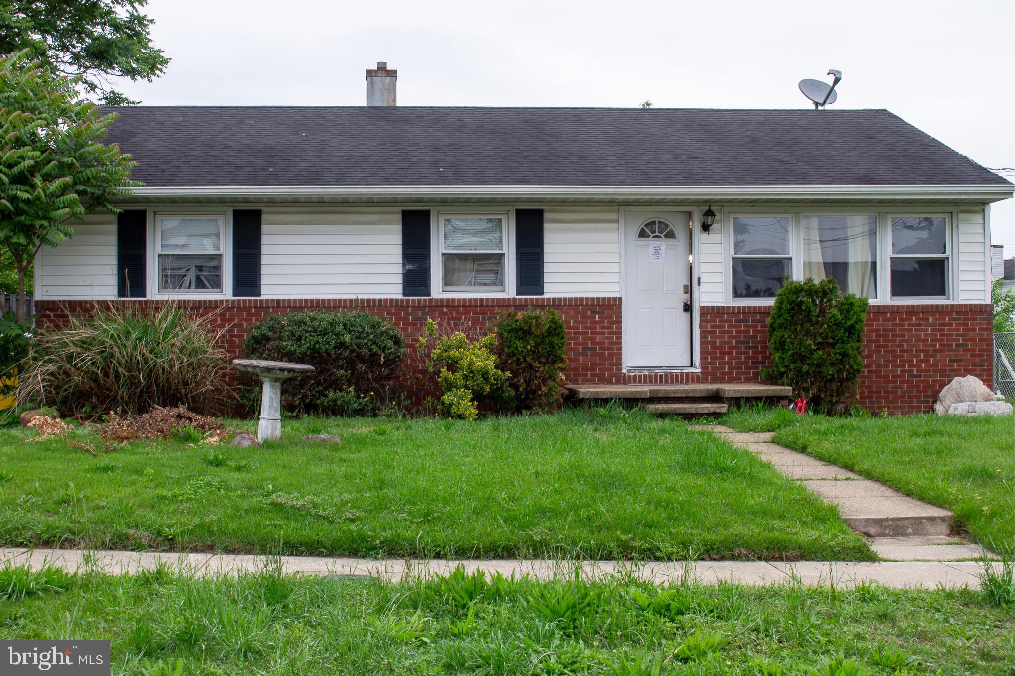 a front view of a house with a garden and plants