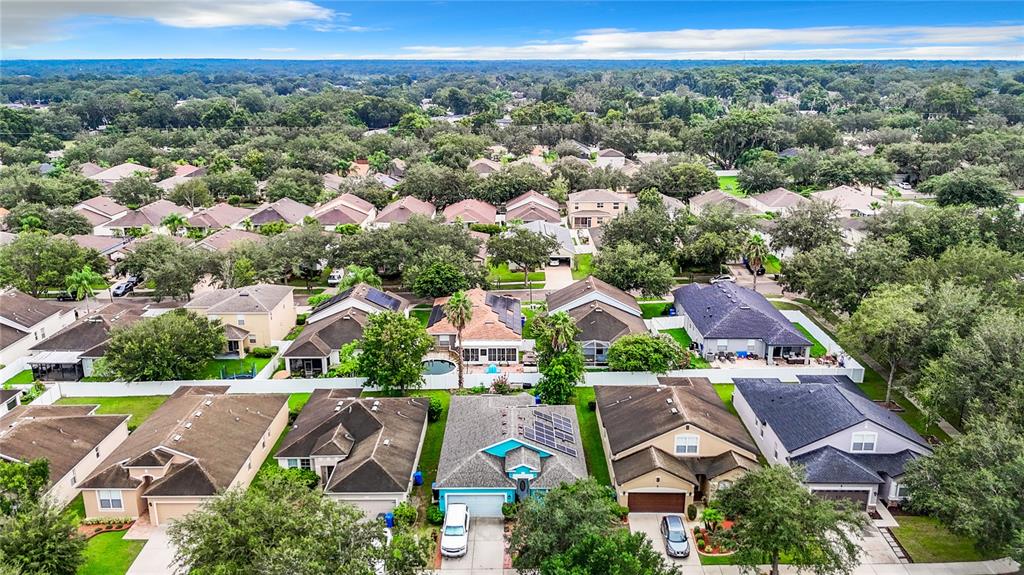 an aerial view of residential houses with outdoor space and street view