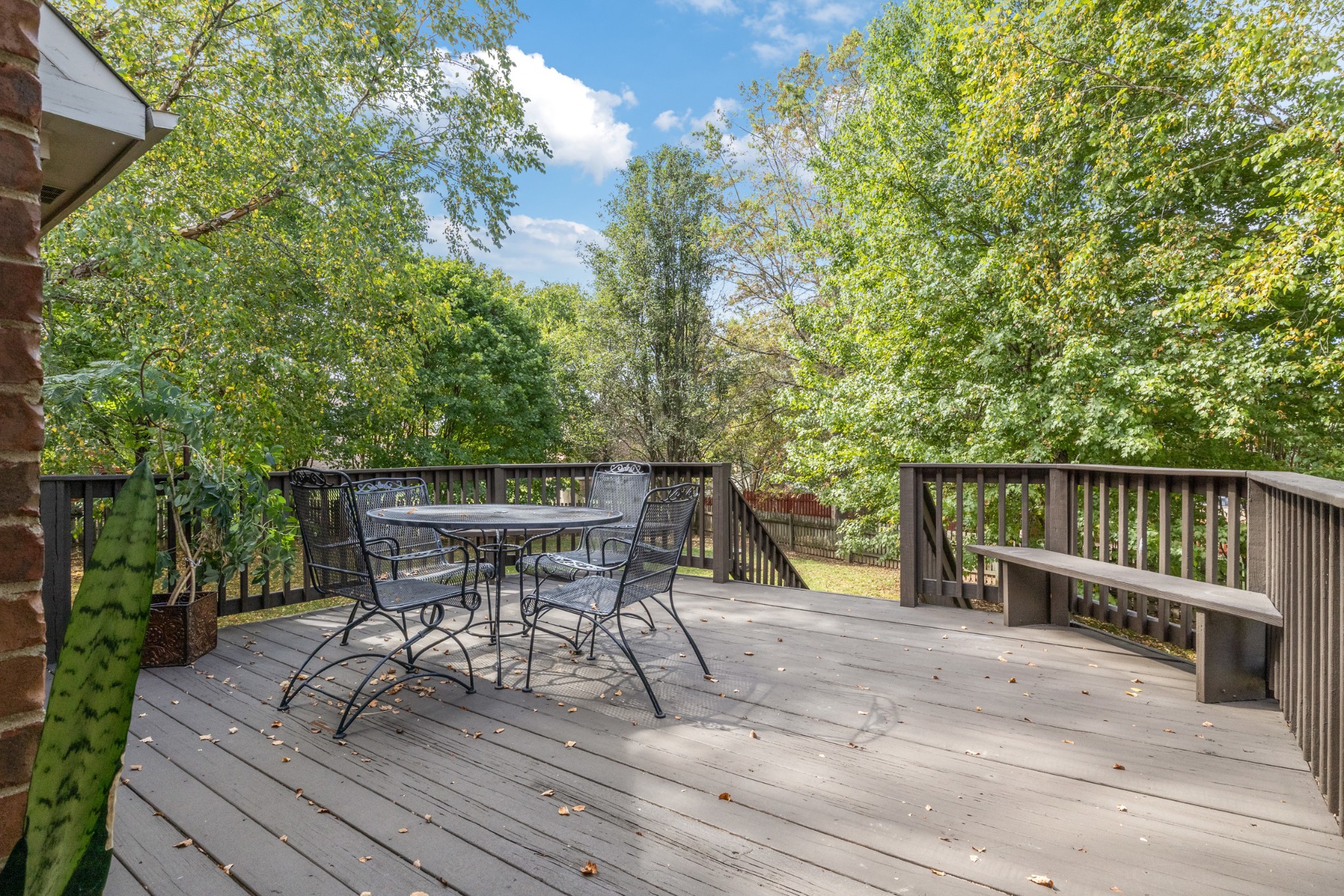 a view of a chairs and table on the wooden deck