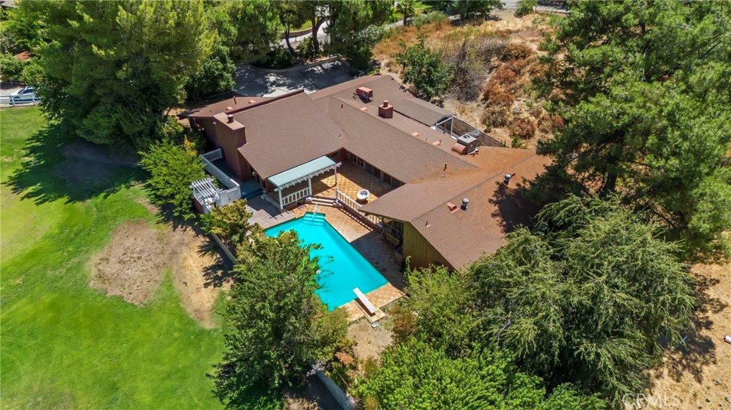 an aerial view of a house with a yard