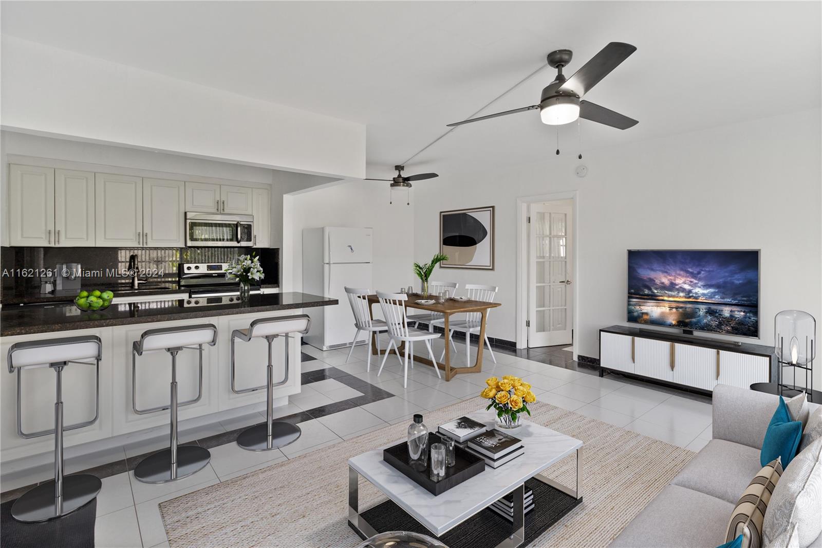 a living room with furniture and a kitchen view