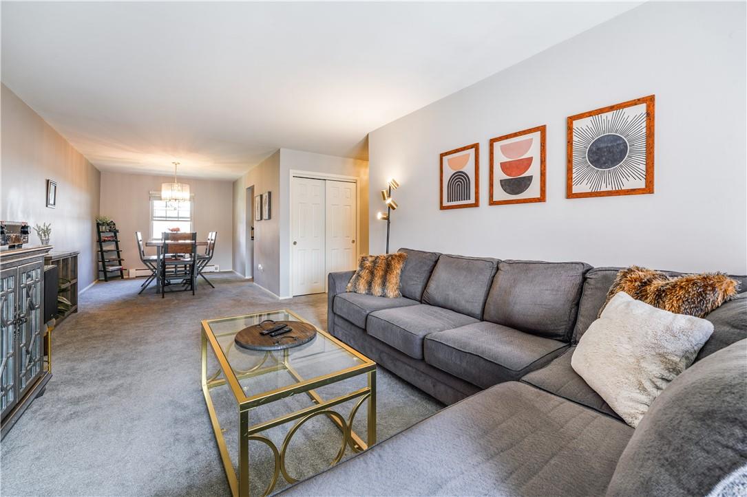 Large sun drenched living room looking towards dining area