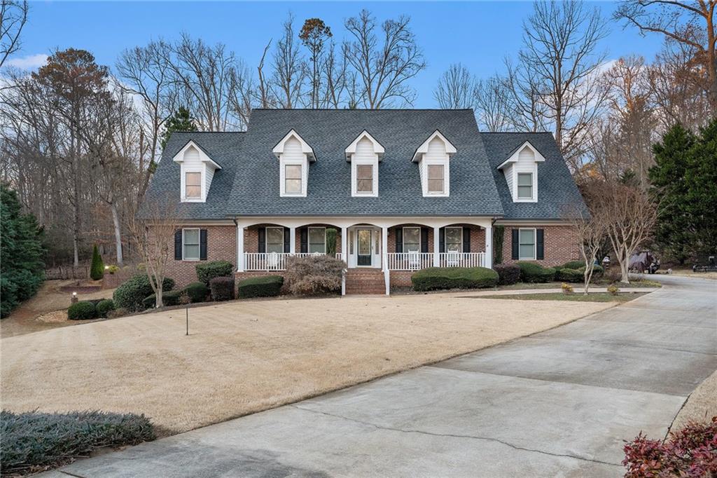 a front view of brick house with a yard