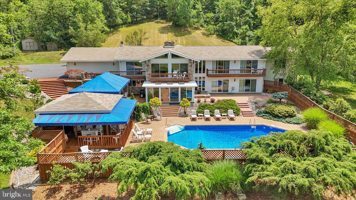 an aerial view of a house with yard swimming pool and outdoor seating