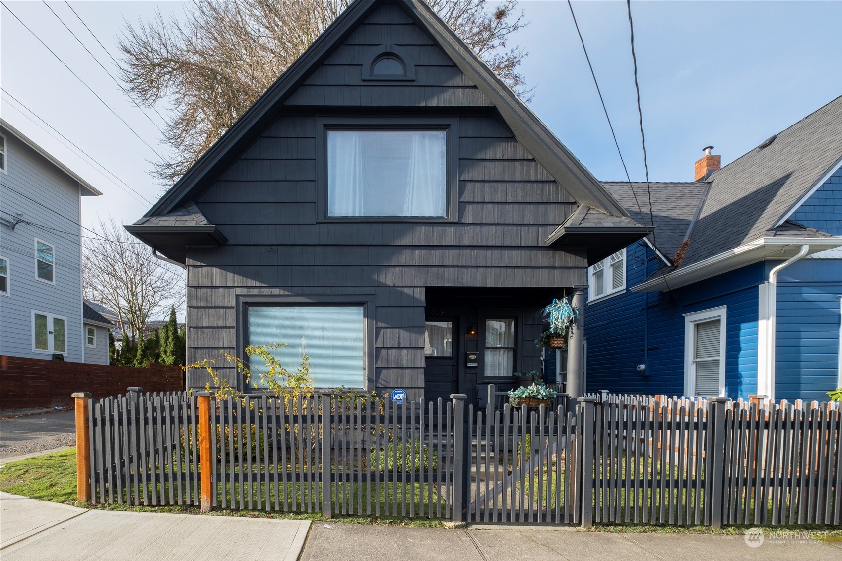 a side view of a house with iron fence