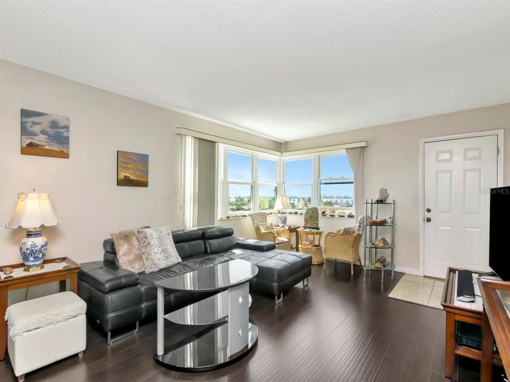 a living room with furniture and wooden floor