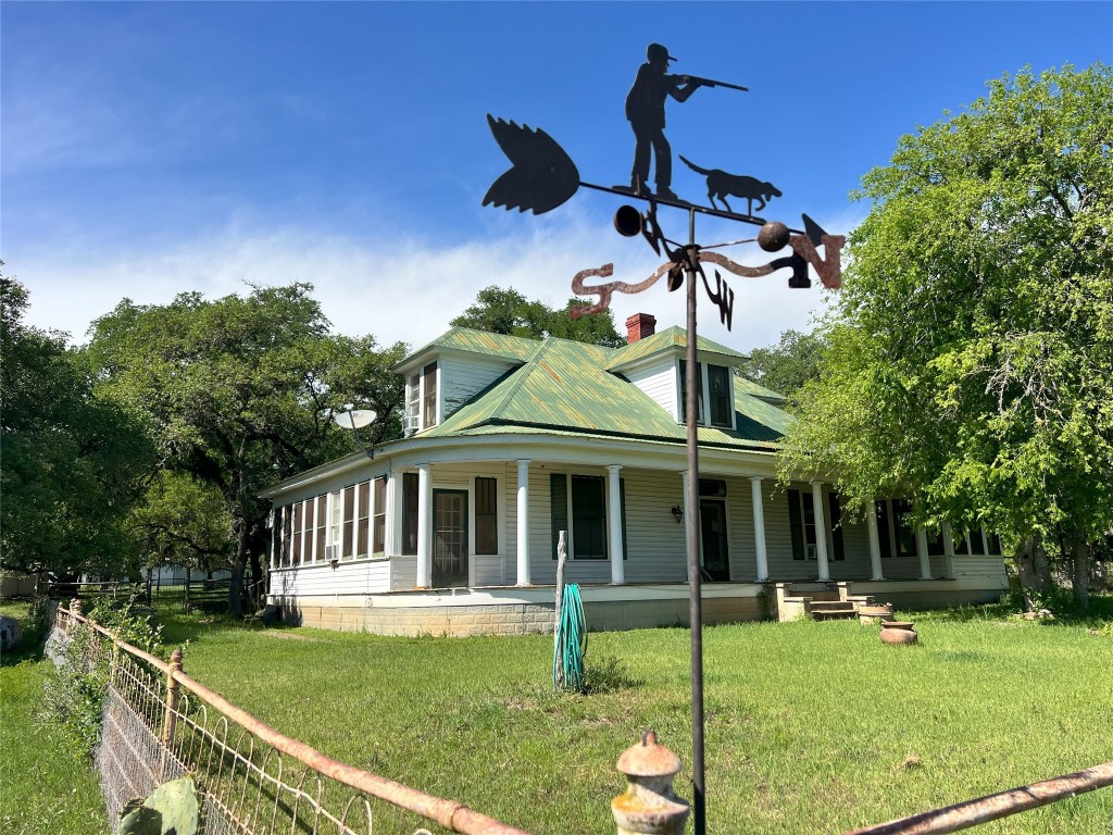 a view of a house with a yard porch and sitting area