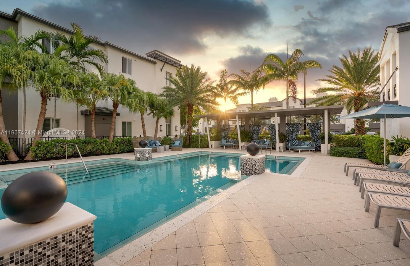 a view of a house with a swimming pool and a chairs