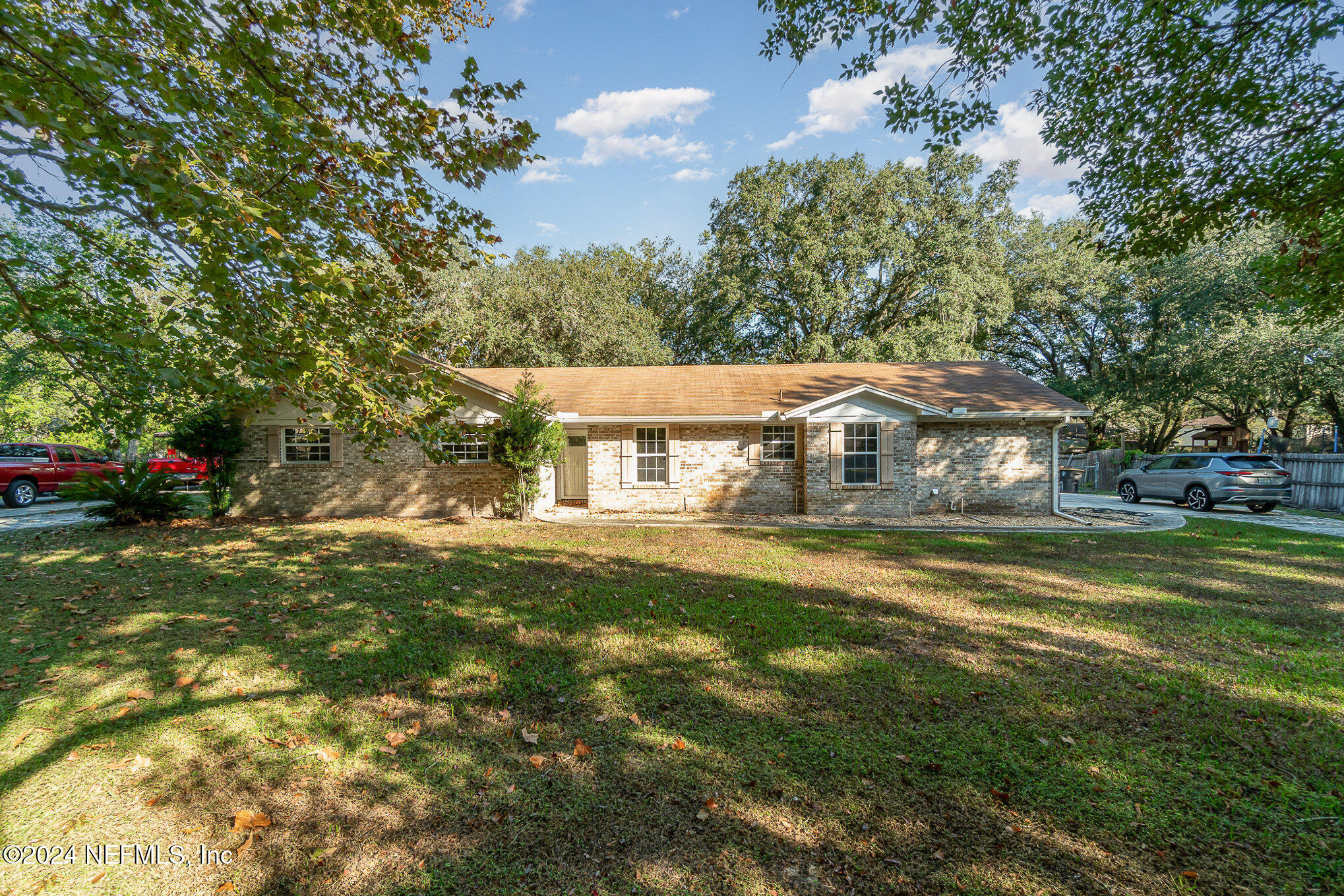 a front view of house with yard and trees