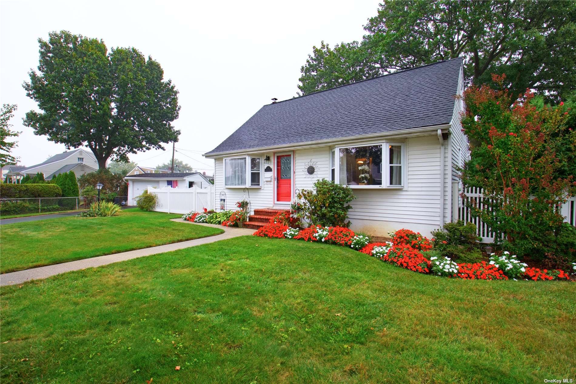 a front view of house with yard and green space