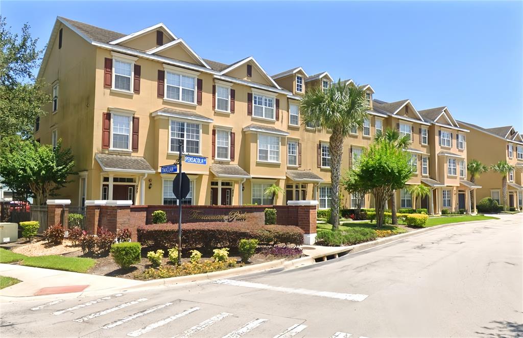 a front view of a residential apartment building with a yard