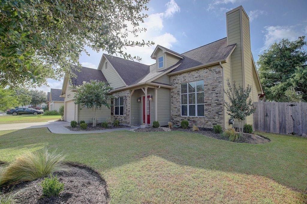 a view of a house with a yard and tree s