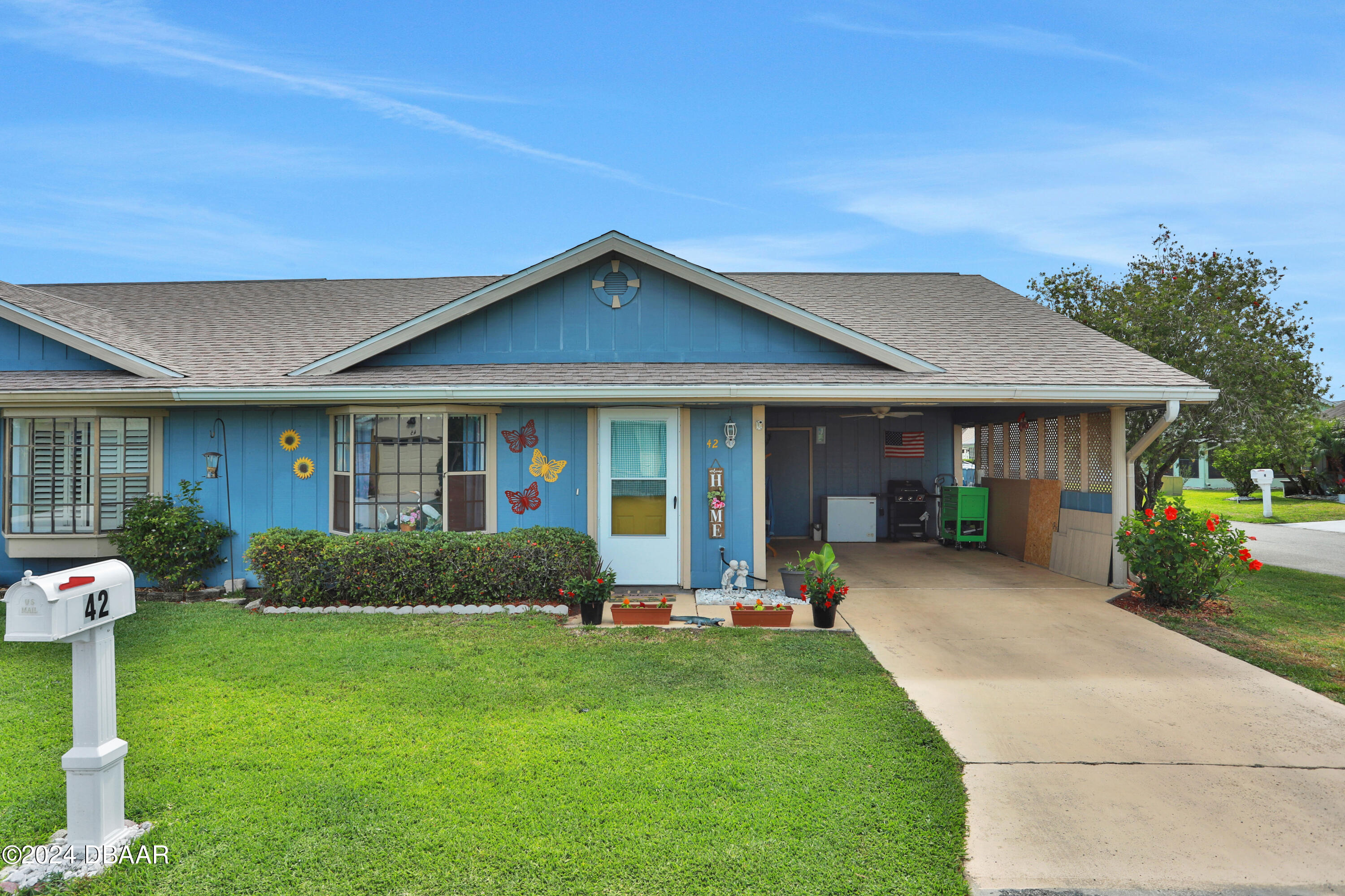 a front view of a house with a yard and porch