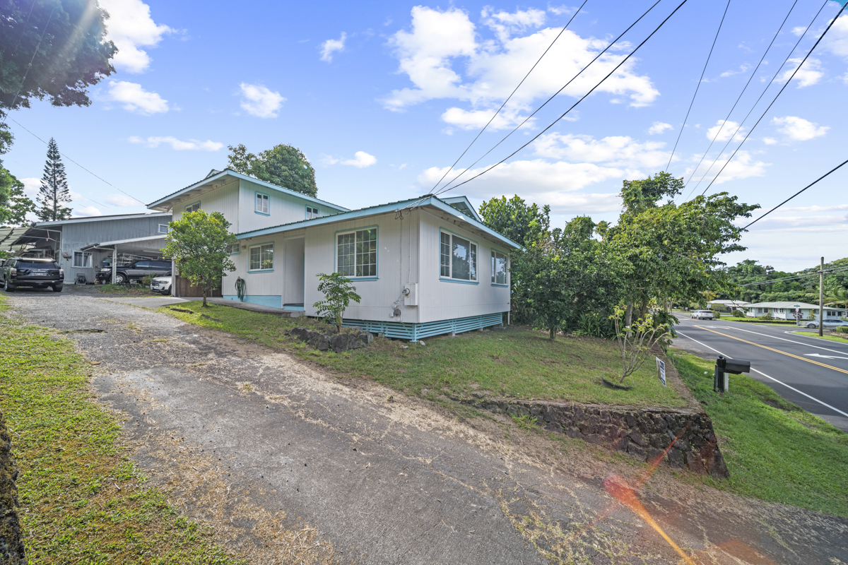 a front view of house with yard and green space