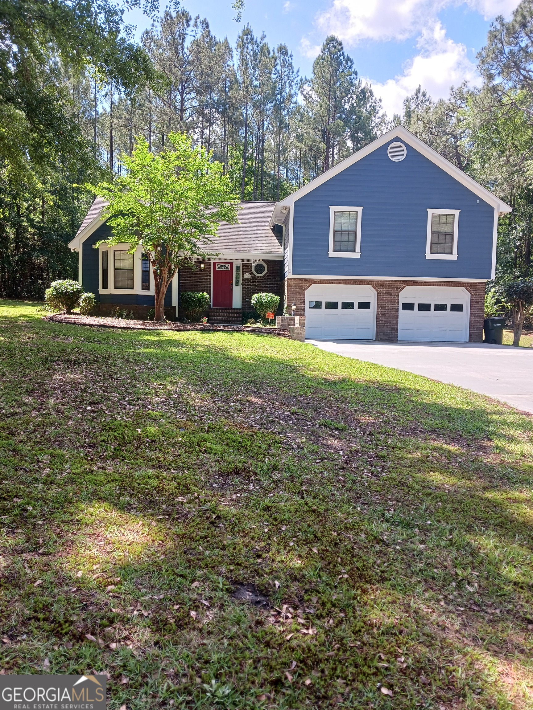 a front view of a house with a garden