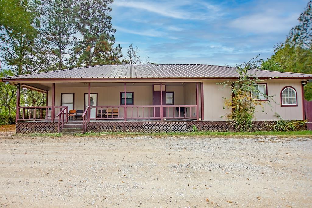 a view of a house with a patio and a yard