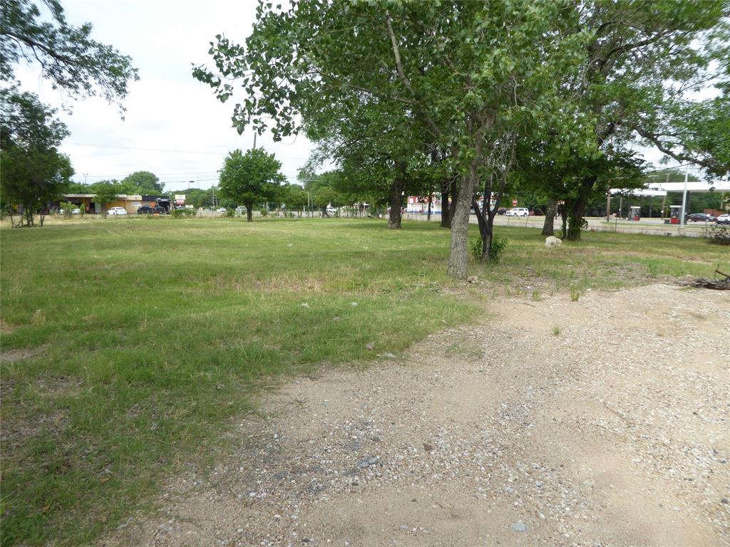 a view of outdoor space with green field and trees