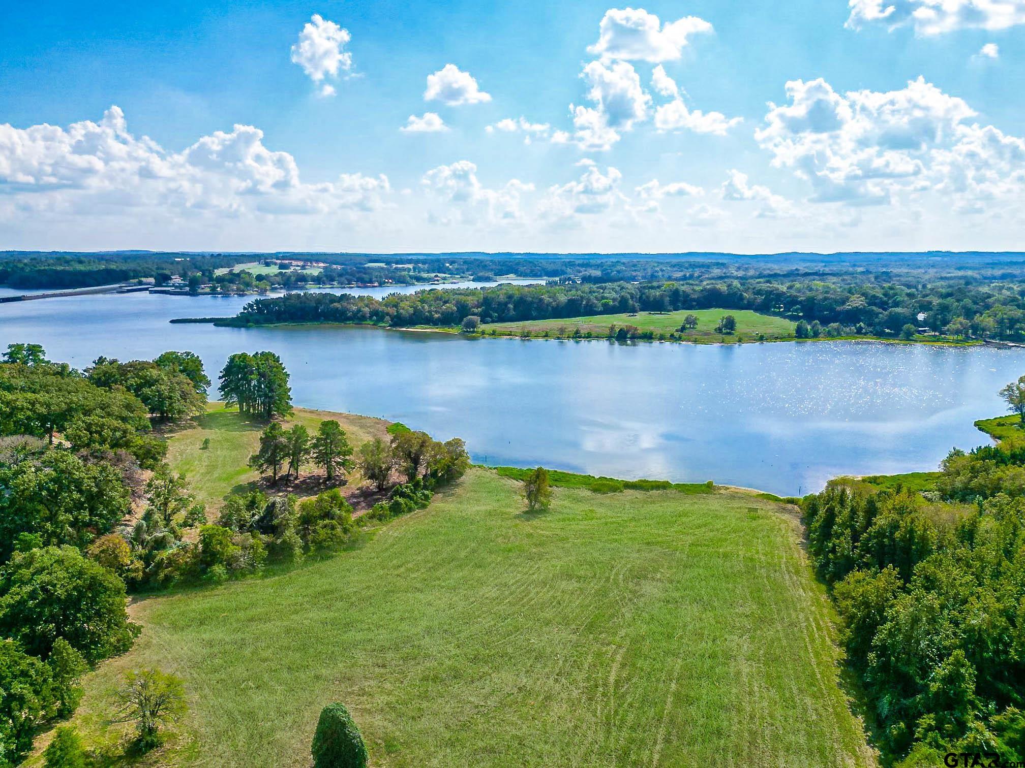 a view of a lake with houses in the back