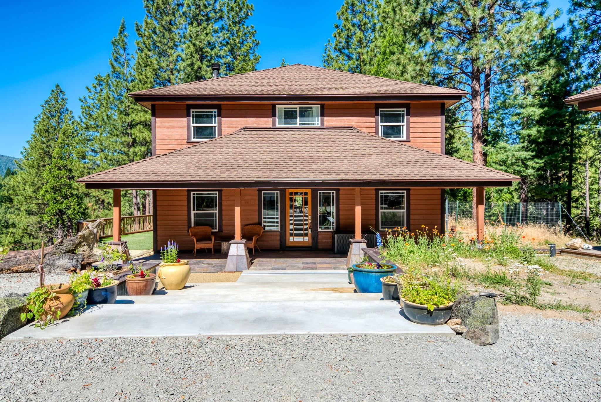 a front view of a house with a yard and sitting area