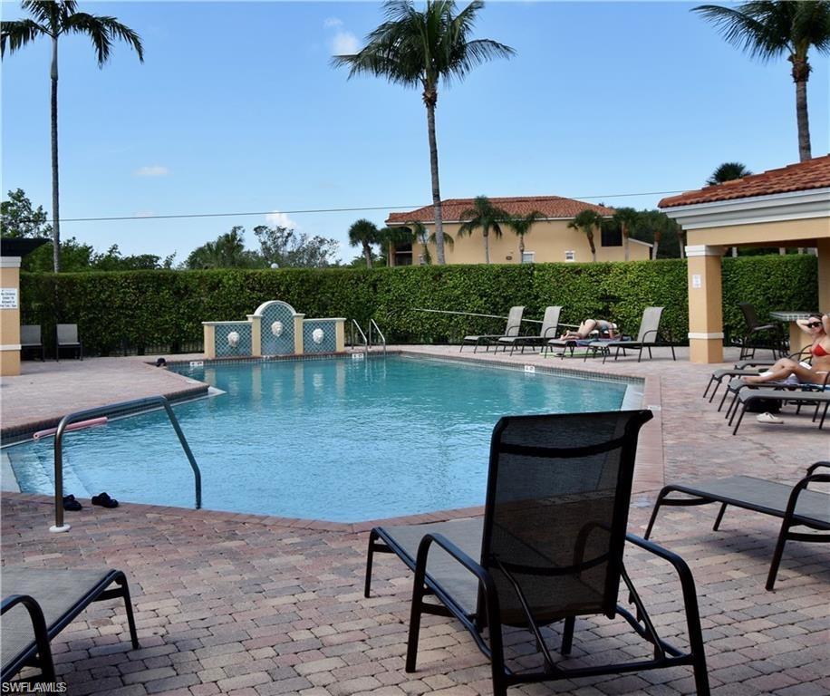 a view of a swimming pool with a table and chairs