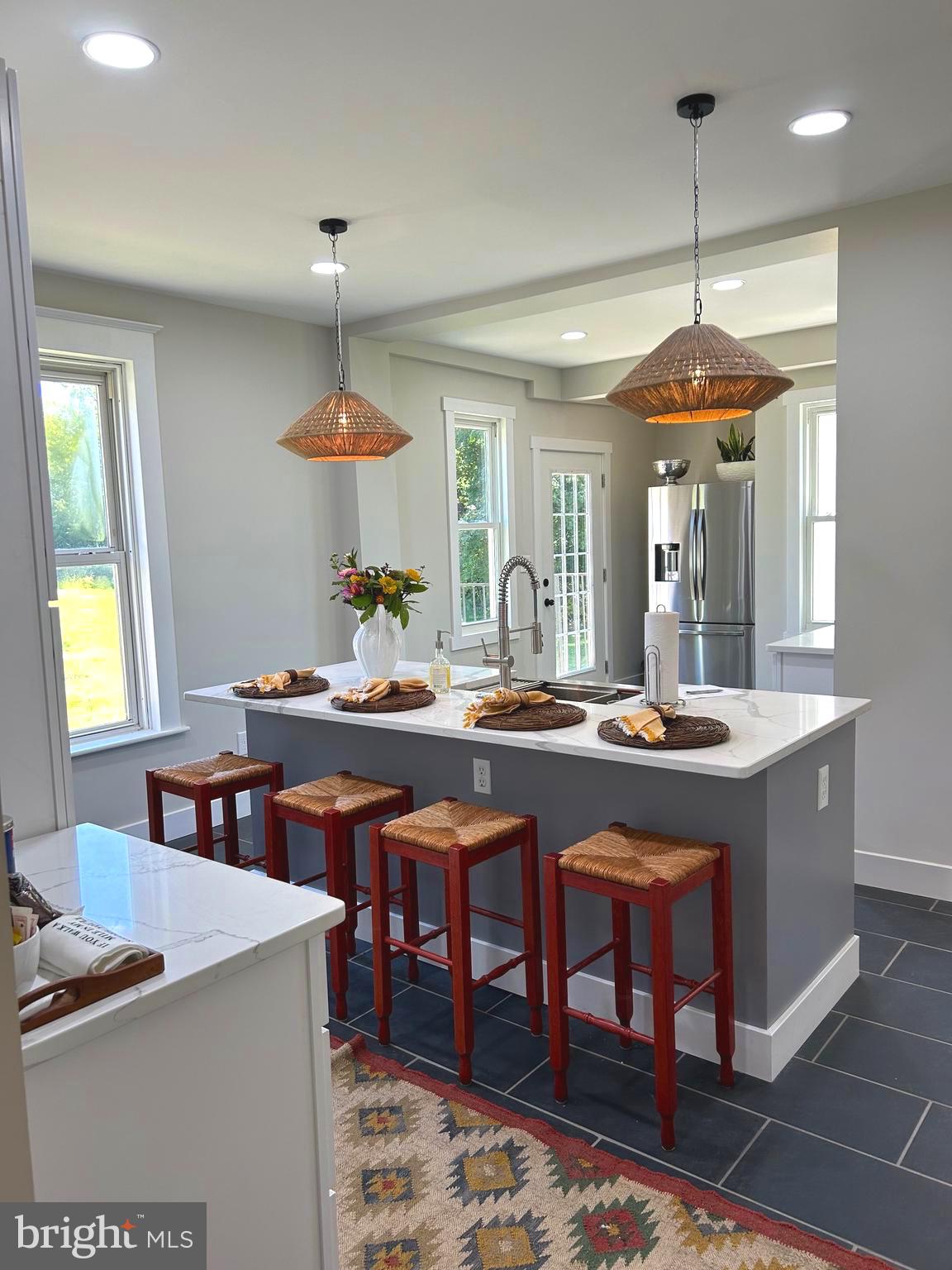 a dining table with chairs and window