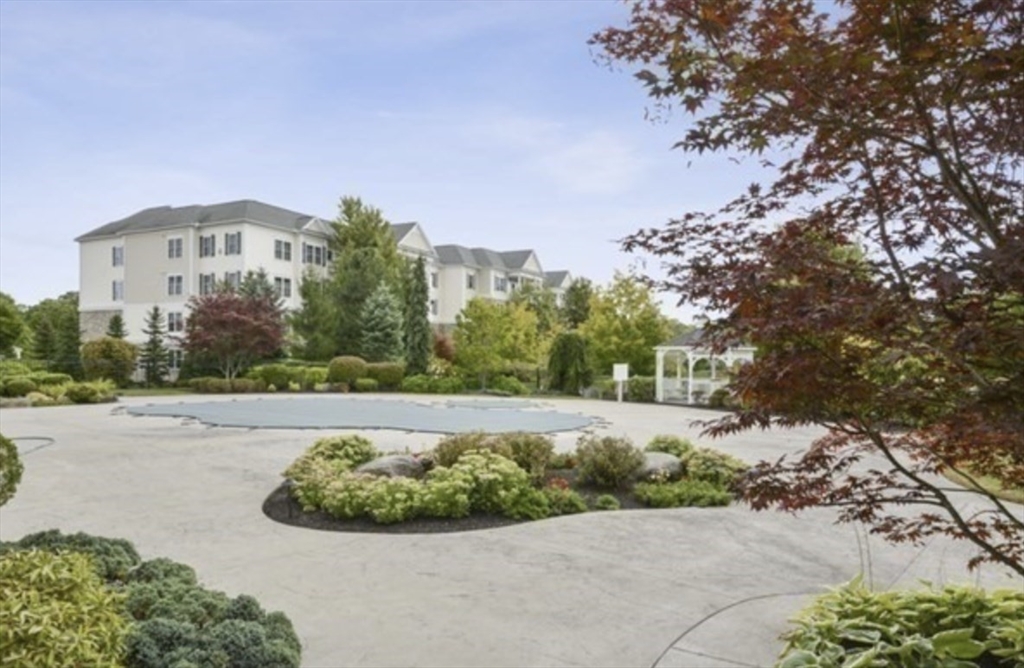 a view of a garden with a building in the background