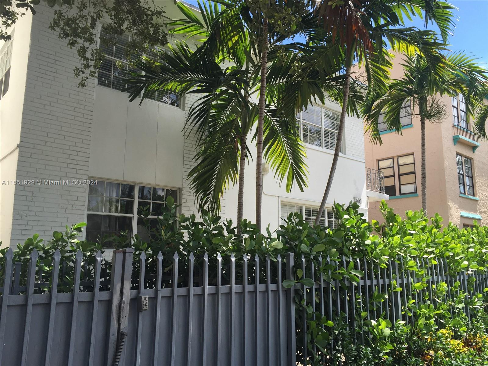 a couple of palm trees in front of house