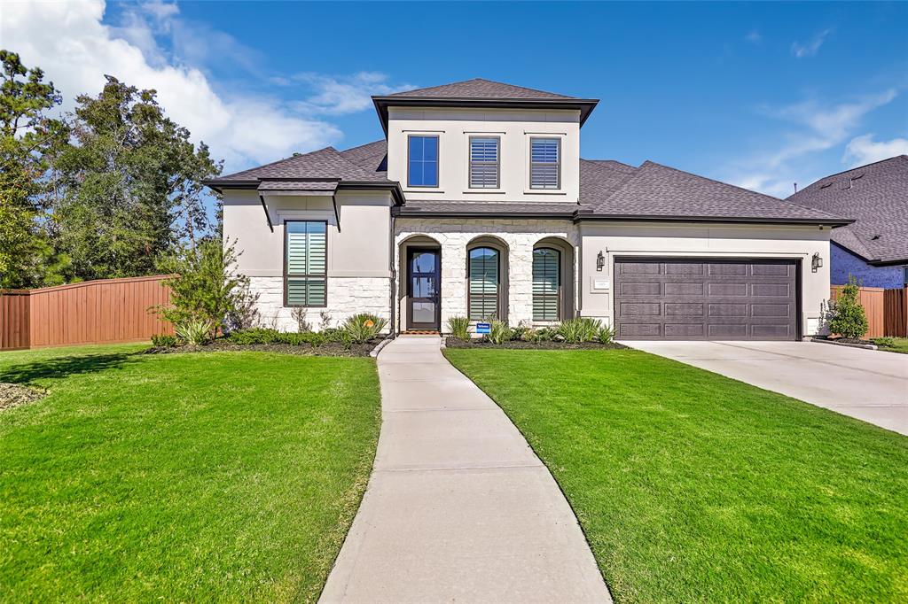 a front view of a house with a yard and garage