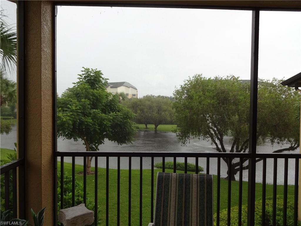 a view of a balcony with yard