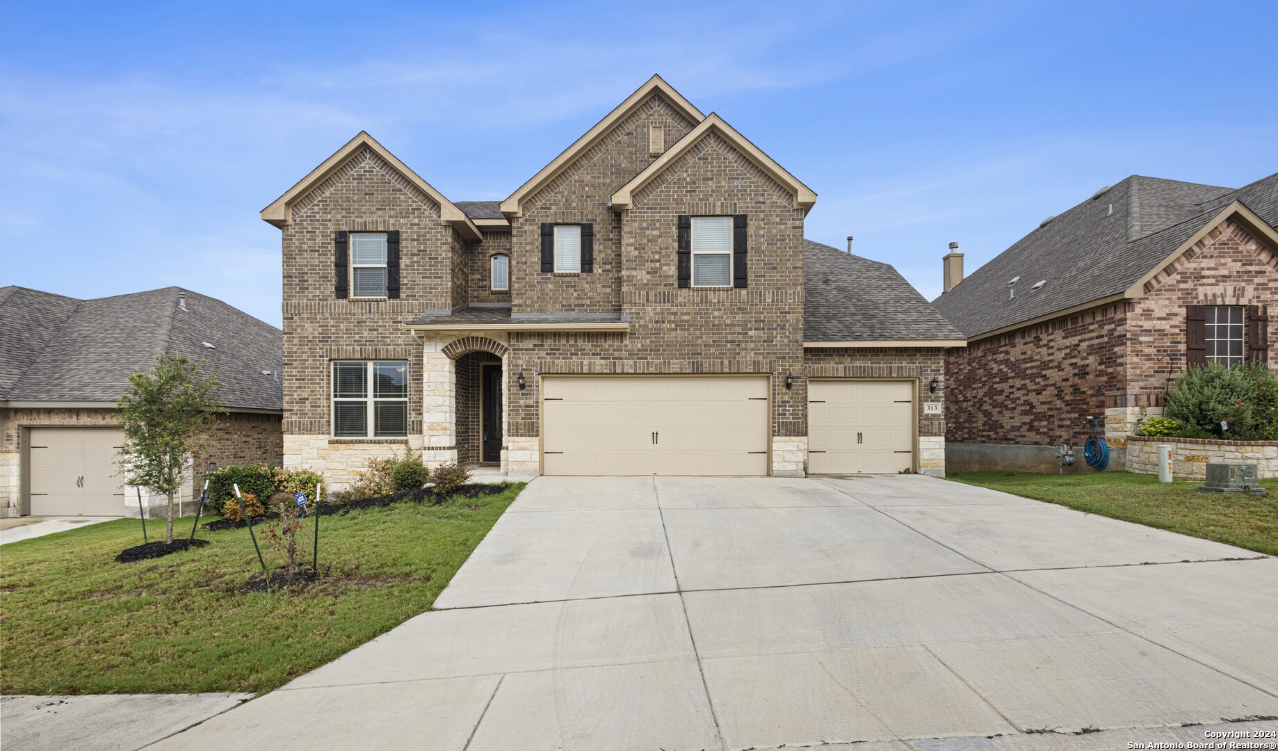 a front view of a house with a yard and garage