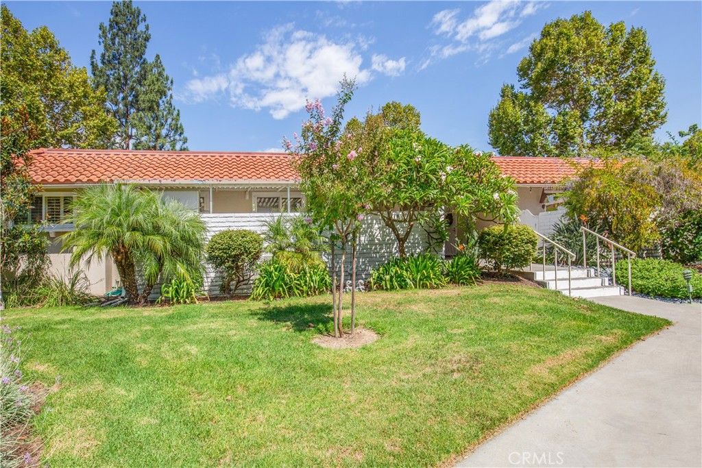 a view of a house with a yard and a garden