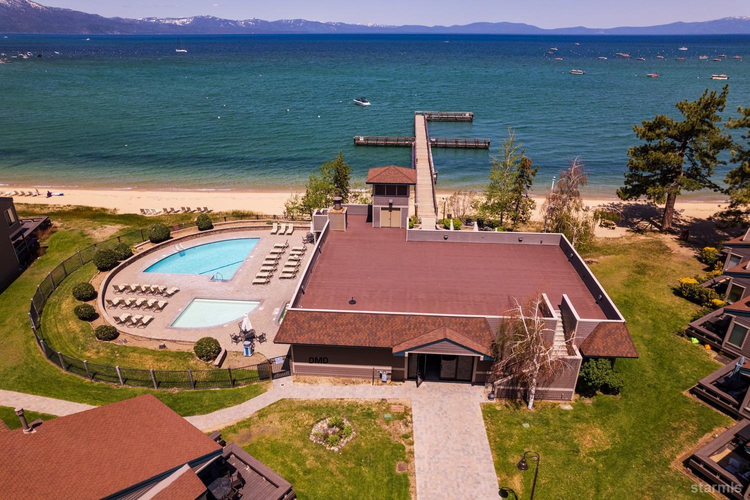 an aerial view of a house with swimming pool and big yard