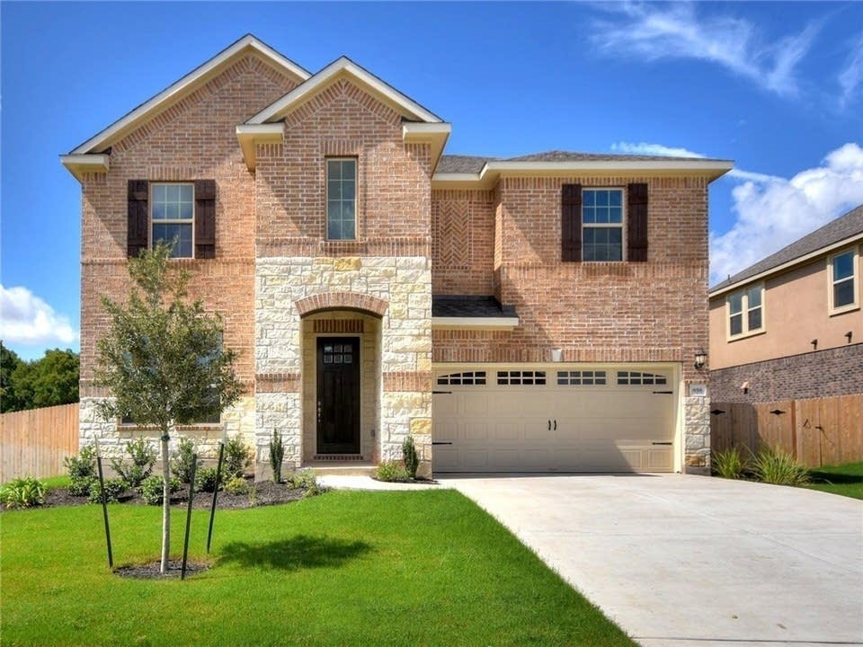 a front view of a house with a yard