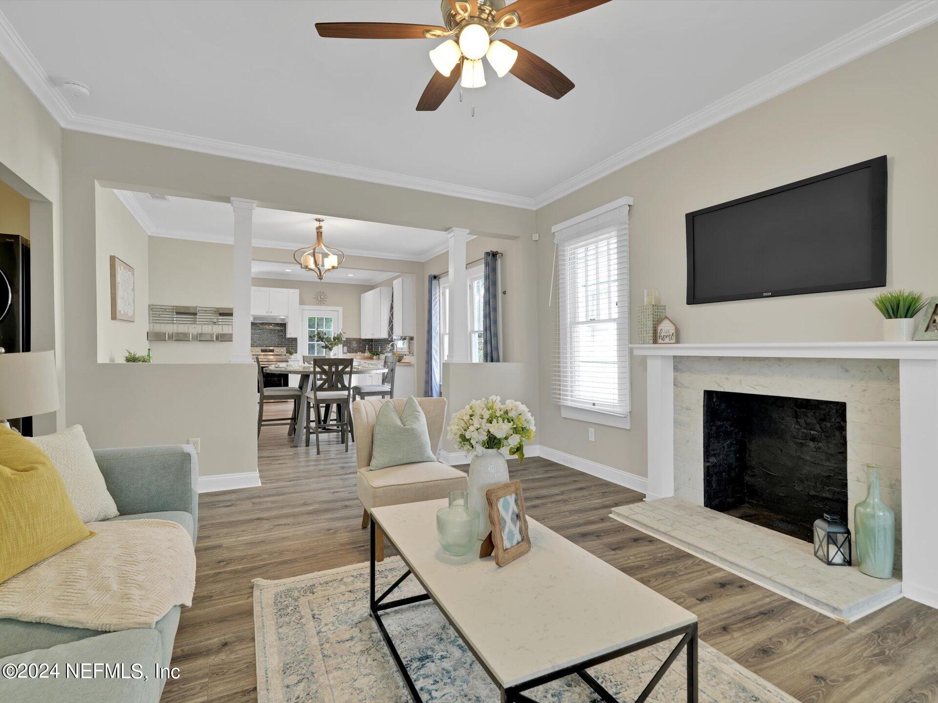 a living room with furniture a flat screen tv and a fireplace