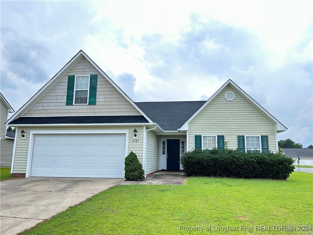 a front view of a house with a yard and garage