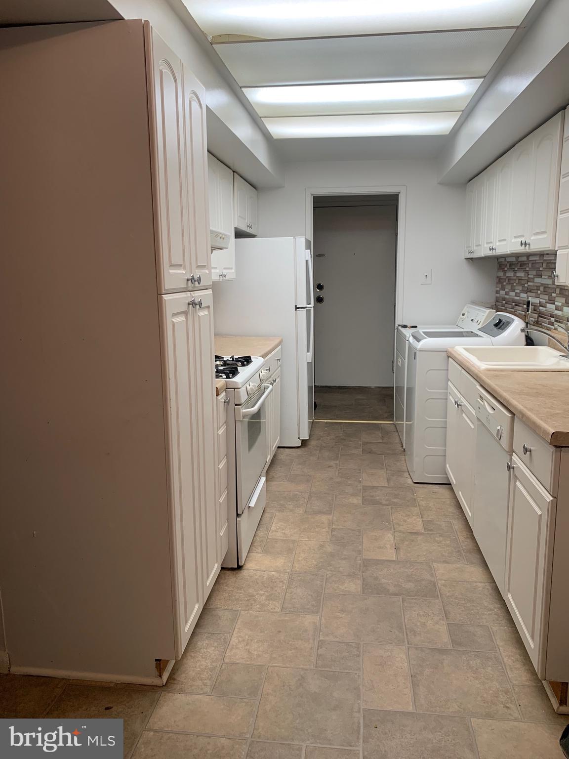 a kitchen with a sink stove and refrigerator