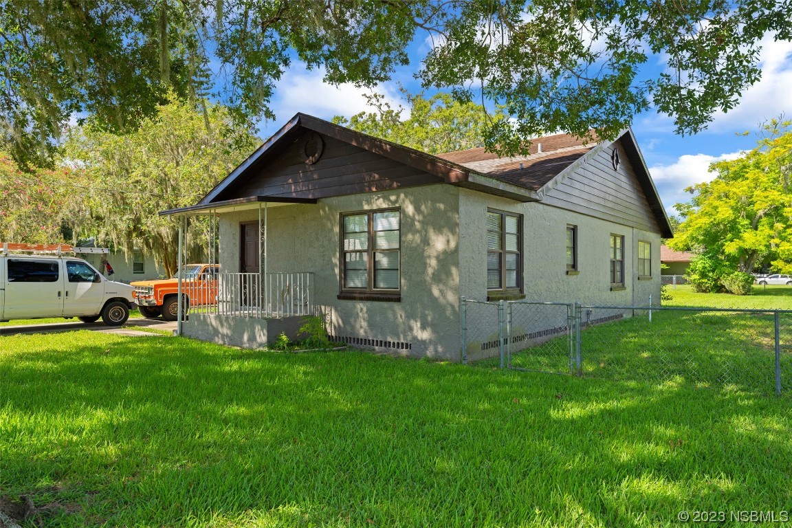 a front view of house with yard and green space