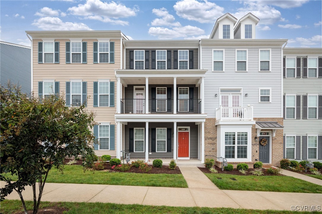 a front view of a residential apartment building with a yard