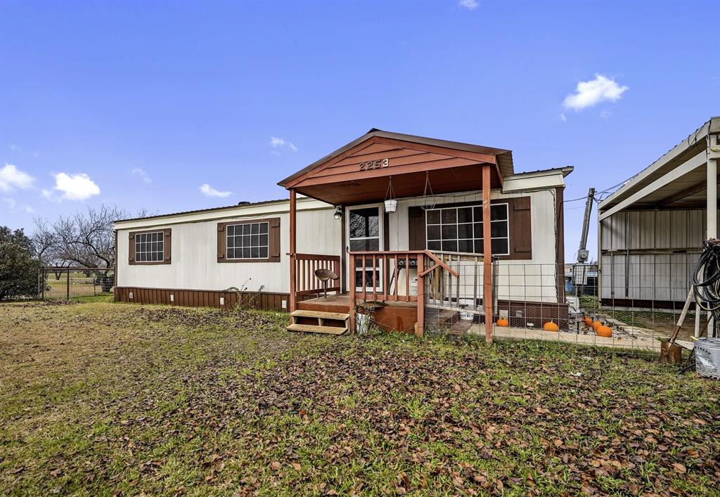 a backyard of a house with table and chairs