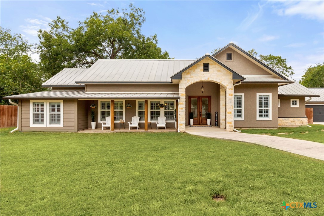 a front view of a house with a garden and porch